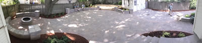 A beautiful paver patio with a fire pit and sitting walls. 
